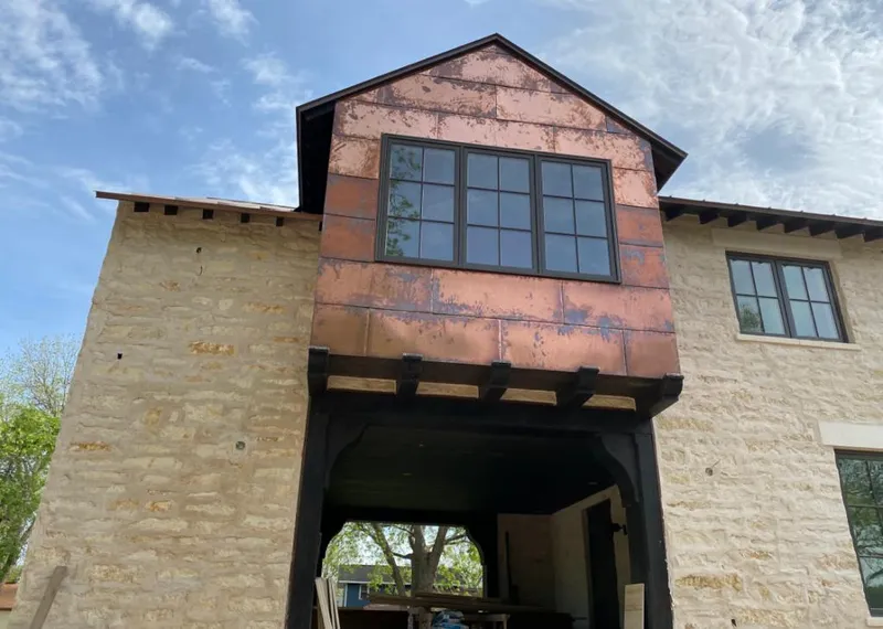 Copper metal panel facade on a stone building for Skylight Installation in Mukwonago